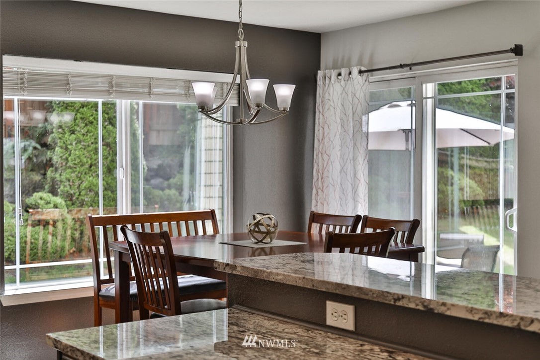 2432 195th Place Southeast, Unit B Bothell, WA 98012 - Photo 12 of 34 a view of a dining room with furniture window and wooden floor