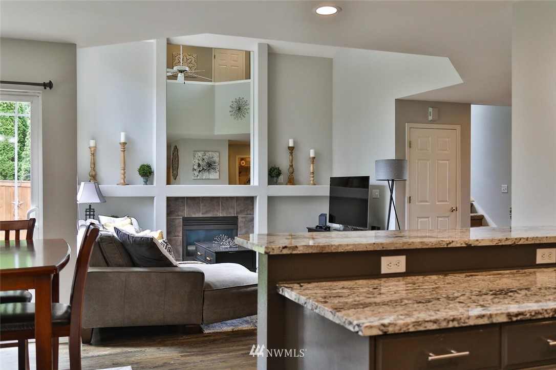 2432 195th Place Southeast, Unit B Bothell, WA 98012 - Photo 15 of 34 a living room with furniture and a fireplace