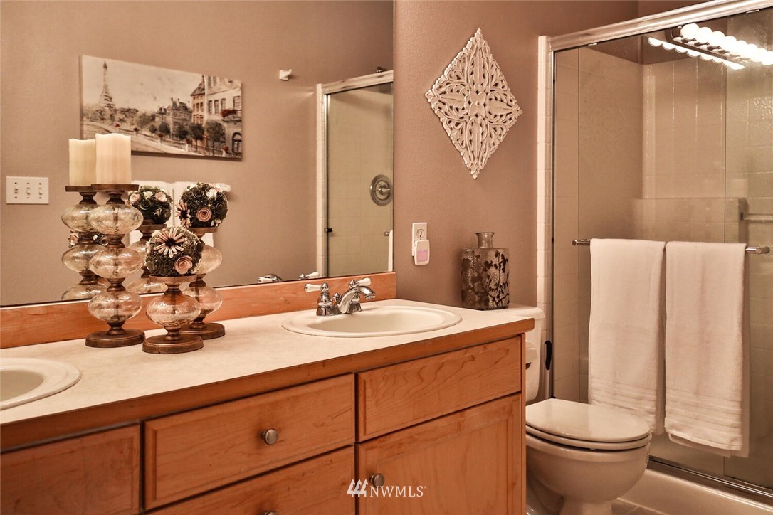 2432 195th Place Southeast, Unit B Bothell, WA 98012 - Photo 21 of 34 a bathroom with a sink a toilet and a mirror