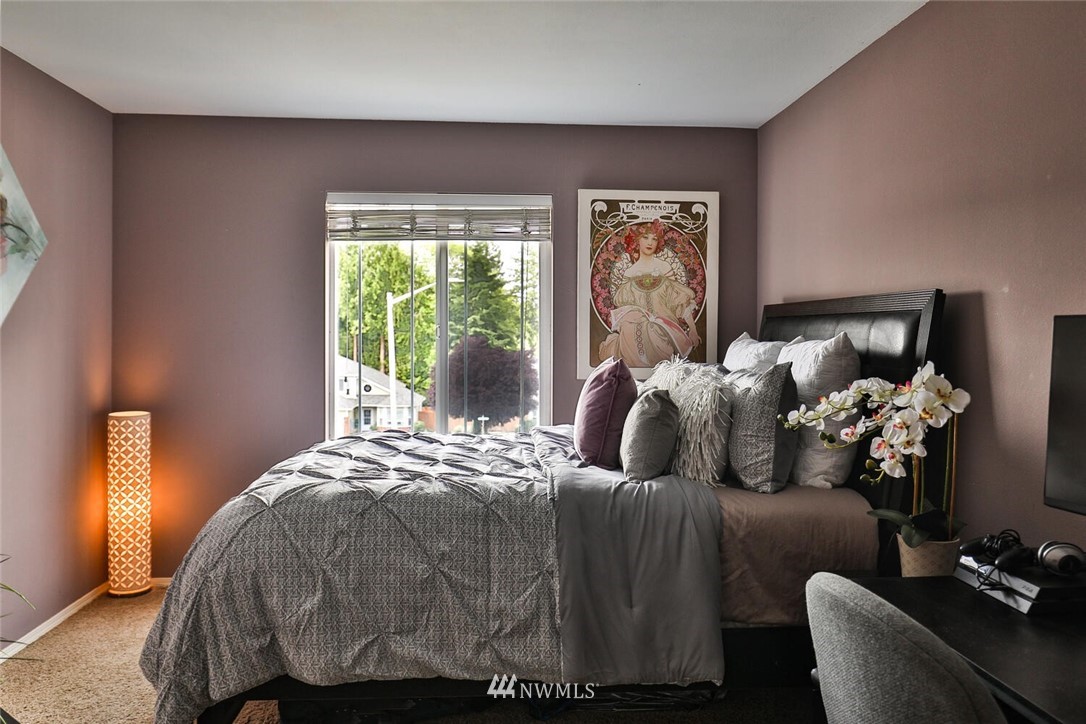 2432 195th Place Southeast, Unit B Bothell, WA 98012 - Photo 23 of 34 a bed sitting in a bedroom next to a window
