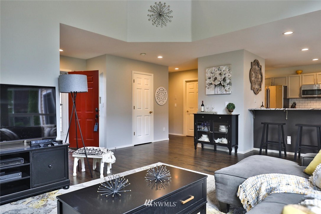 2432 195th Place Southeast, Unit B Bothell, WA 98012 - Photo 6 of 34 a living room with furniture and a flat screen tv