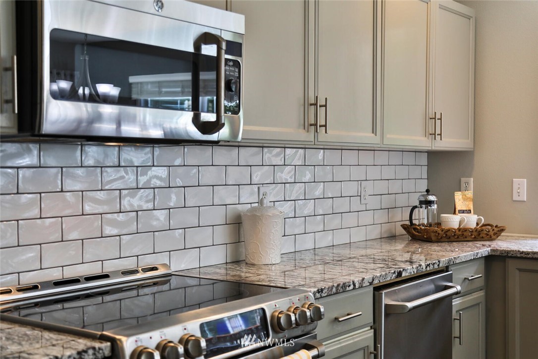 2432 195th Place Southeast, Unit B Bothell, WA 98012 - Photo 10 of 34 a kitchen with granite countertop a sink and cabinets