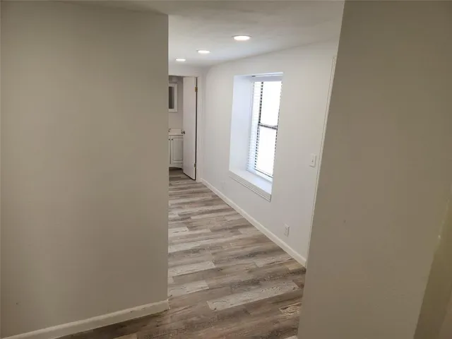 a view of an entryway with wooden floor