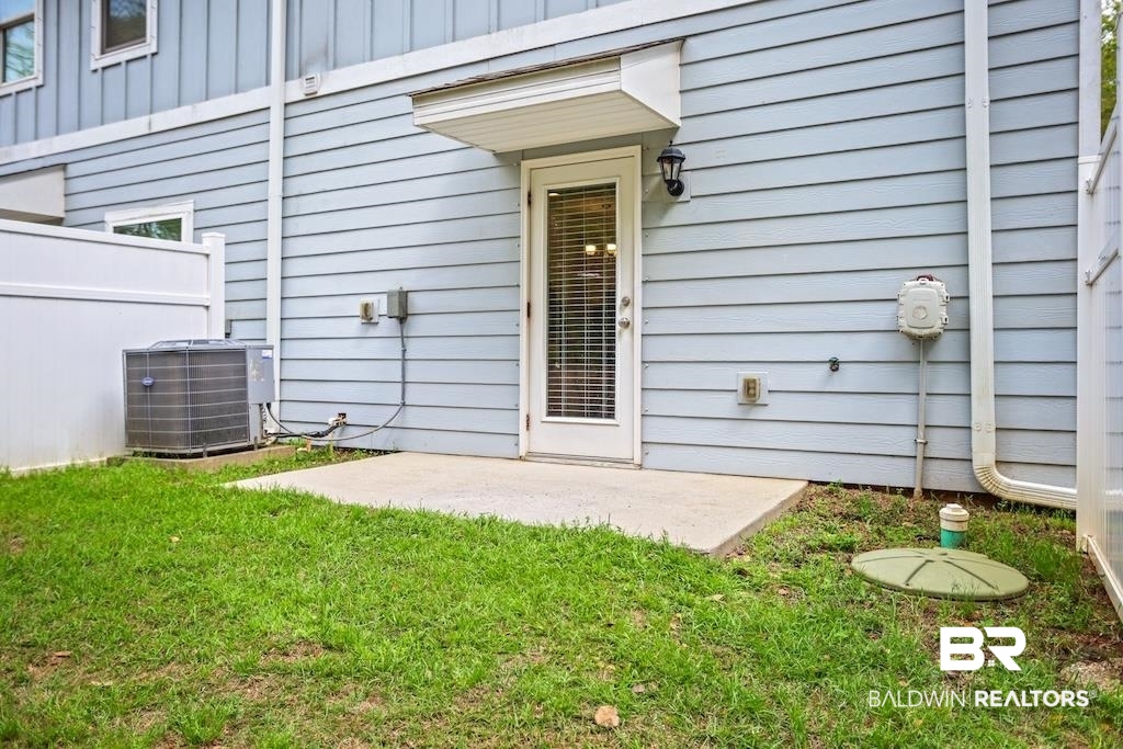 25806 Pollard Road, Unit 27 Daphne, AL 36526 - Photo 10 of 46 Property entrance with a patio area and board and batten siding