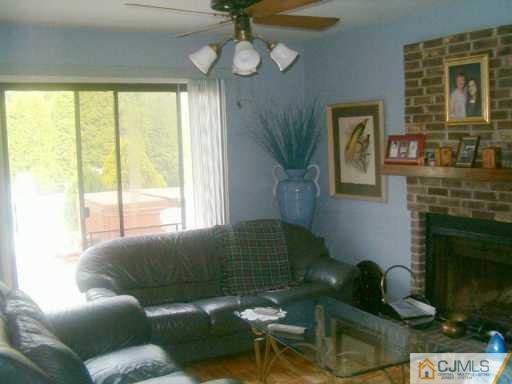 68 Higgins Road Old Bridge, NJ 08857 - Photo 3 of 5 a living room with furniture windows and a fireplace