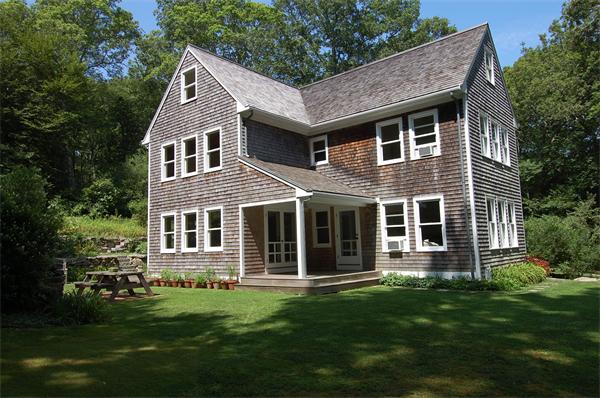 215 River Road Westport, MA 02790 - Photo 1 of 27 a front view of a house with a garden