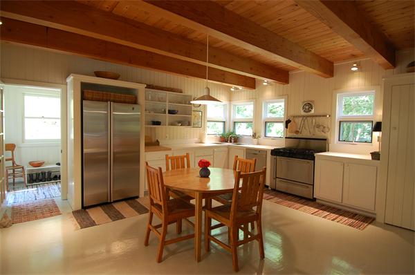 215 River Road Westport, MA 02790 - Photo 6 of 27 a kitchen with a dining table chairs and refrigerator