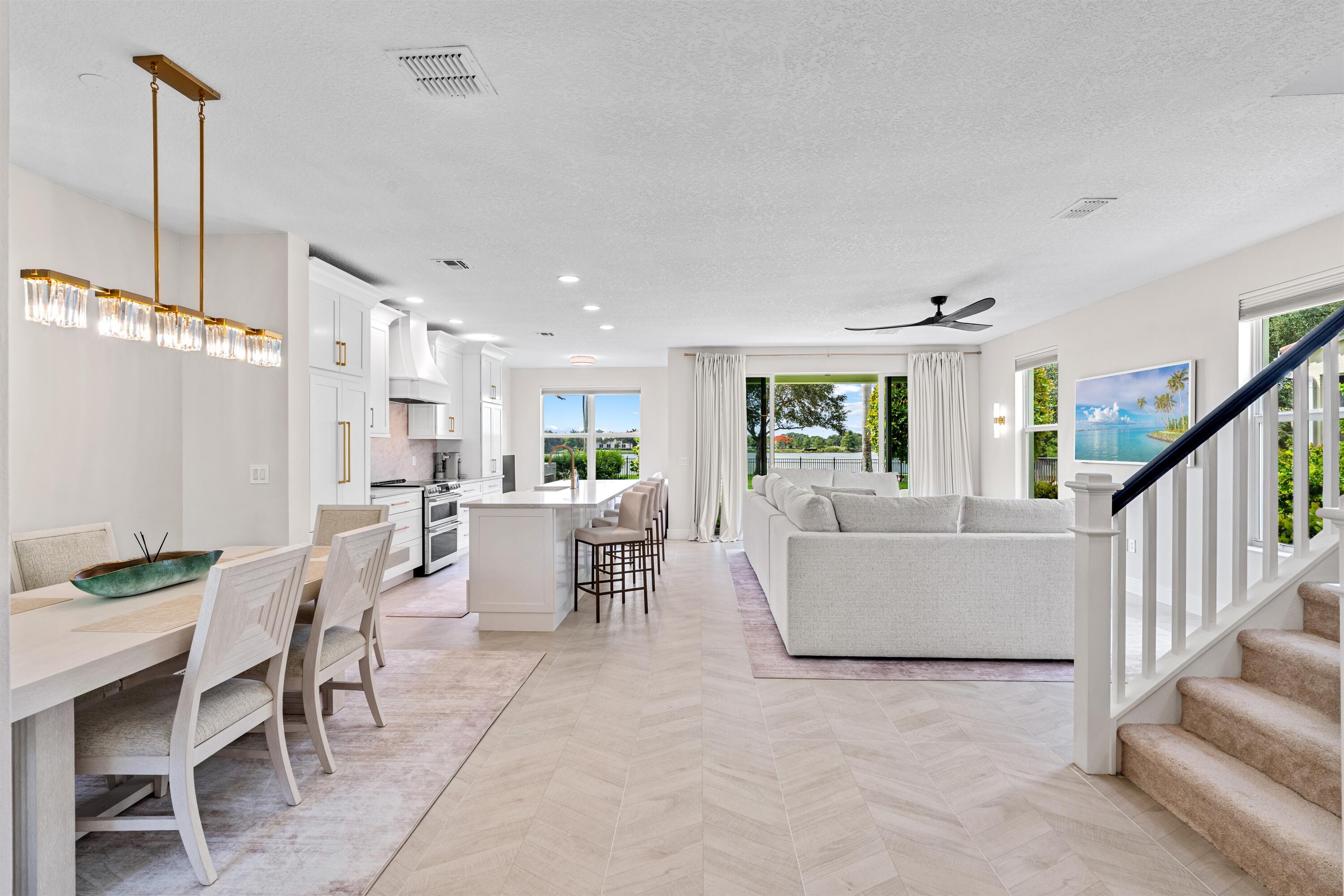 1570 Northwest 48th Place Boca Raton, FL 33431 - Photo 5 of 30 a living room with furniture a dining table and chairs