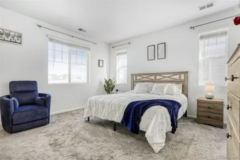 a bedroom with a bed and a couch