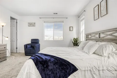 a bedroom with a bed and a couch
