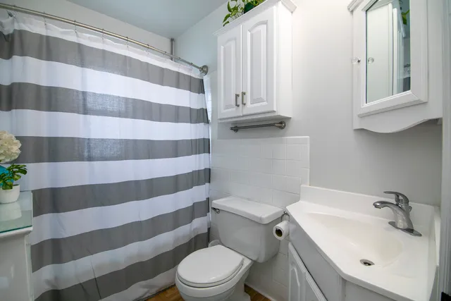 a white toilet sitting next to a sink