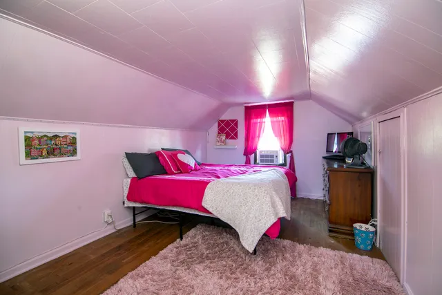 a bedroom with a bed and a view of bathroom