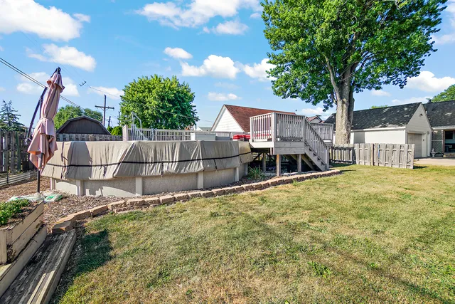 a white house that has tree in front of it