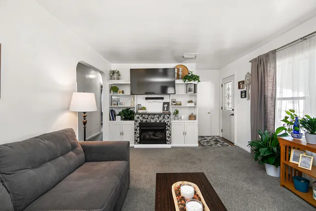 a living room with furniture and a fireplace