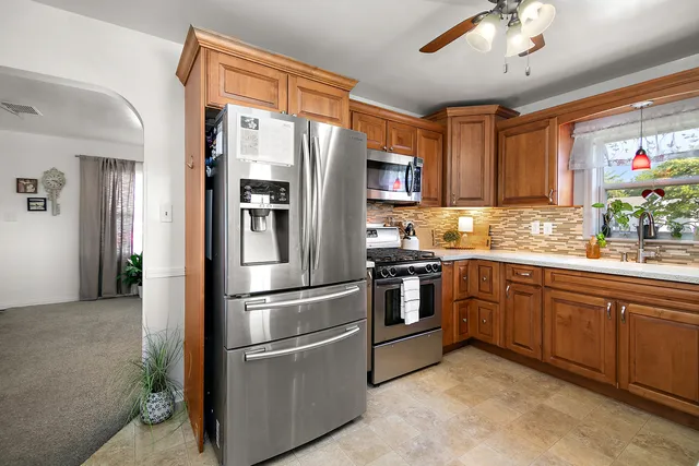 a kitchen with stainless steel appliances granite countertop a refrigerator oven a sink and dishwasher