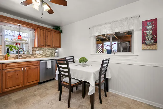 a kitchen with stainless steel appliances granite countertop a stove a sink dishwasher and cabinets with wooden floor