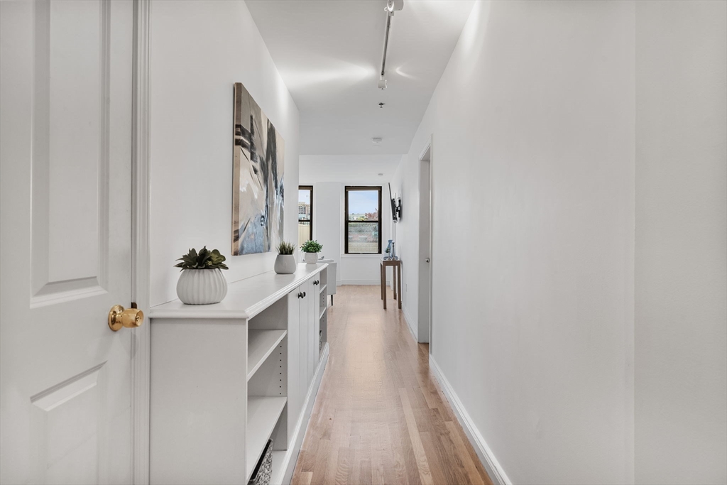 4 Charlesgate East, Unit 601 Boston, MA 02215 - Photo 11 of 33 a bathroom with a sink a large mirror and vanity