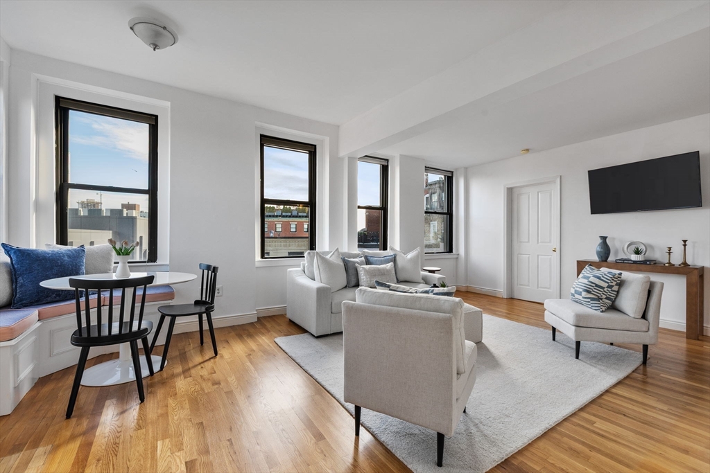 4 Charlesgate East, Unit 601 Boston, MA 02215 - Photo 12 of 33 a living room with fireplace furniture and a flat screen tv