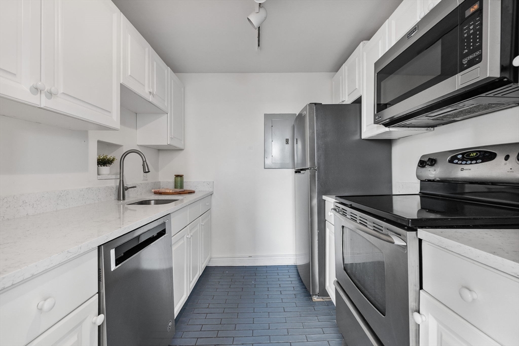 4 Charlesgate East, Unit 601 Boston, MA 02215 - Photo 15 of 33 a kitchen with stainless steel appliances granite countertop a sink stove and refrigerator
