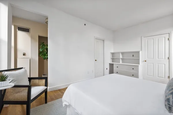a large white bed in a white room