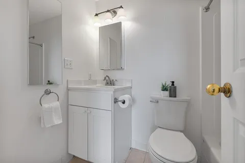 a white toilet sitting next to a bathroom sink