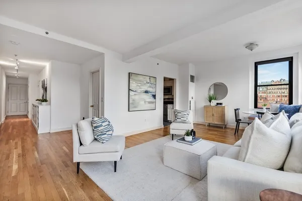 a living room with furniture and wooden floor