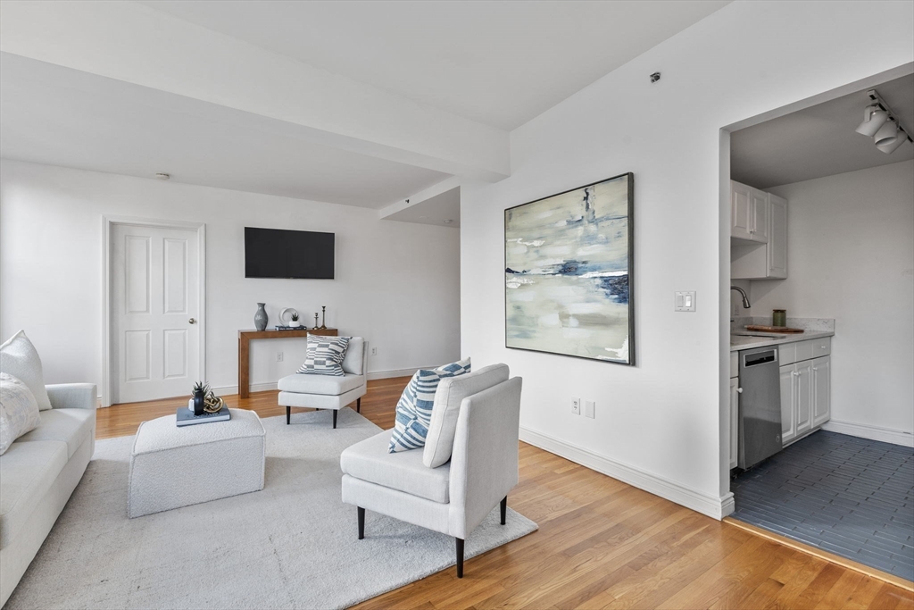 4 Charlesgate East, Unit 601 Boston, MA 02215 - Photo 10 of 33 a living room with furniture and a flat screen tv