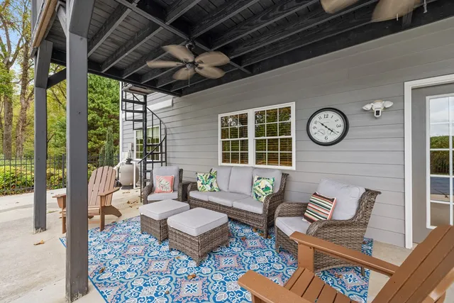 a kitchen with stainless steel appliances granite countertop a stove top oven a sink a dining table and chairs with wooden floor