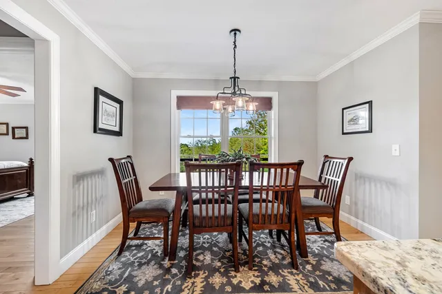 a living room with patio furniture and a floor to ceiling window