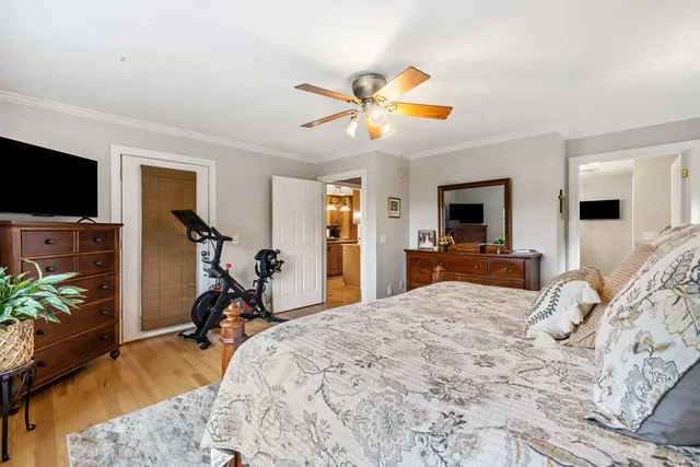 aerial view of a house with swimming pool and trees in the background