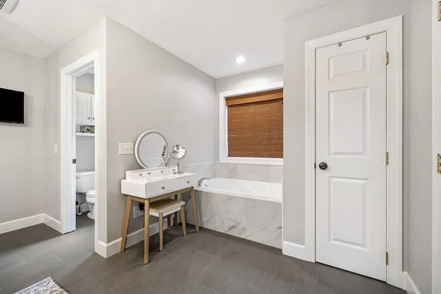 an aerial view of residential house with outdoor space and trees all around