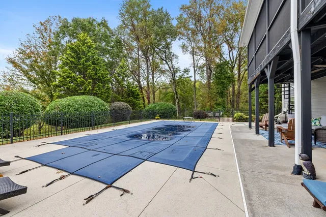 a living room with furniture a table and a potted plant