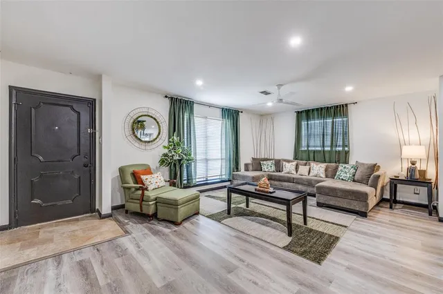 a living room with furniture and wooden floor