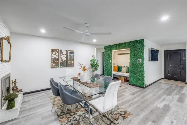a dining room with furniture and wooden floor