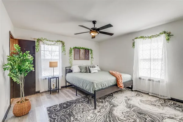 a bedroom with a bed and a potted plant