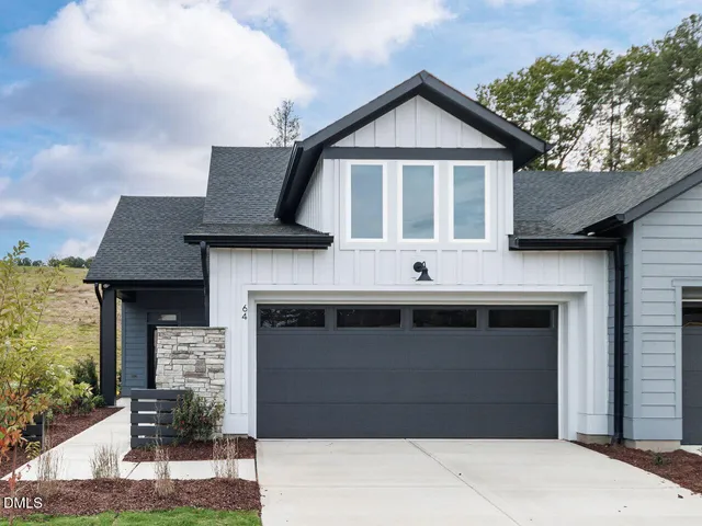 a front view of a house with garage