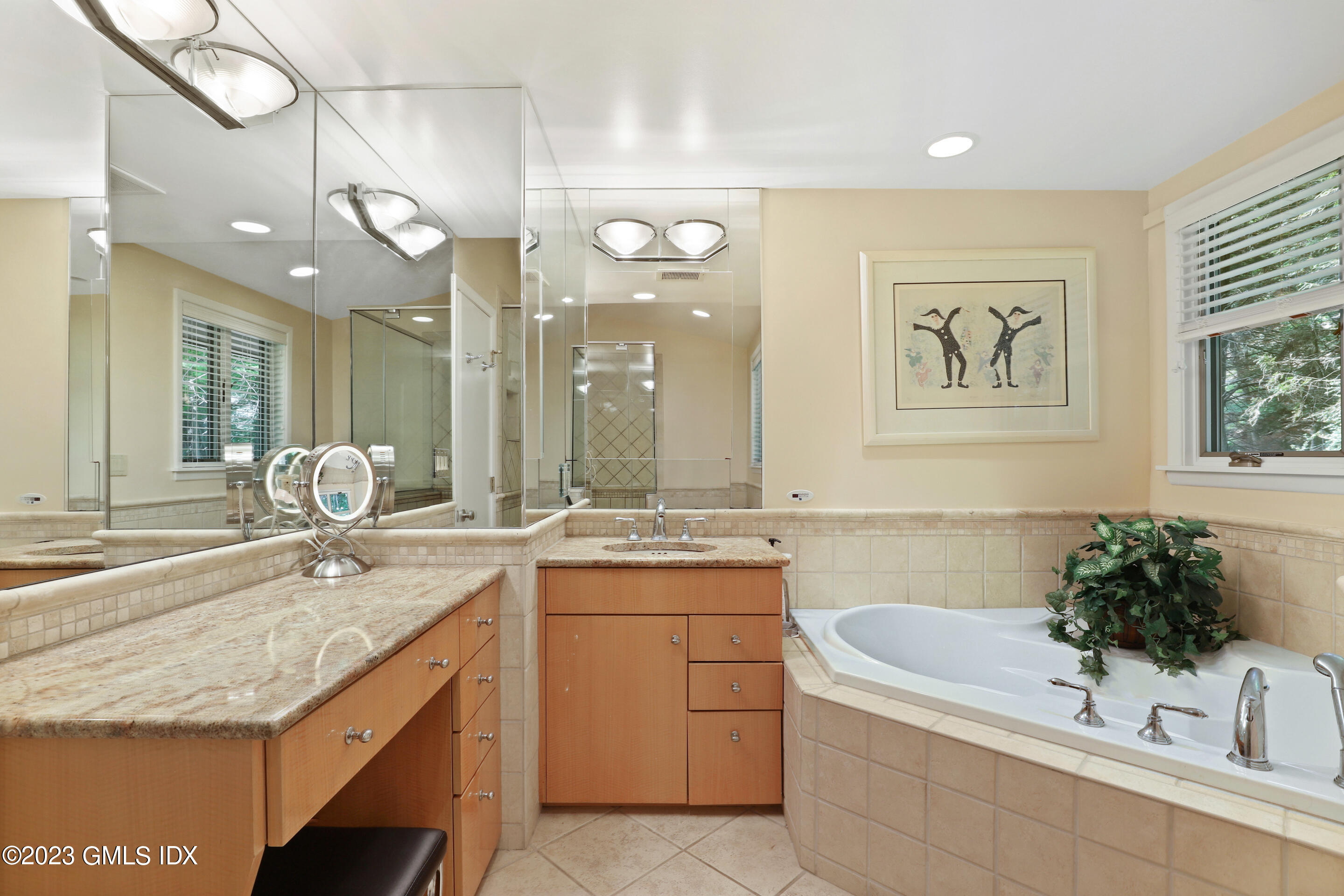 31 Ferncliff Road Cos Cob, CT 06807 - Photo 17 of 28 a bathroom with a granite countertop sink a large mirror and a bathtub