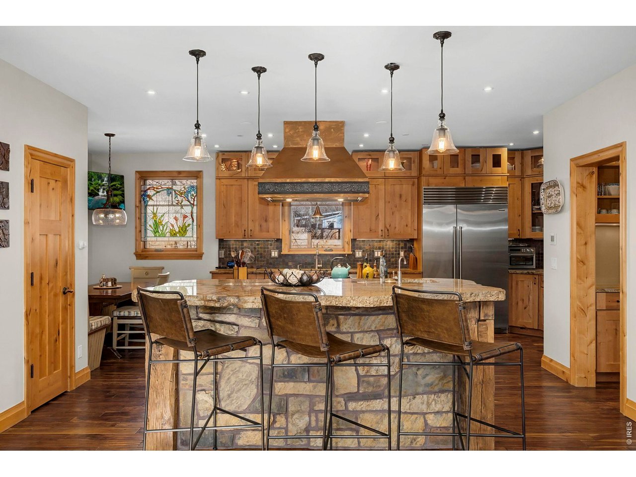 3135 11th Street Boulder, CO 80304 - Photo 11 of 50 a view of kitchen with stainless steel appliances kitchen island granite countertop dining table chairs and a living room