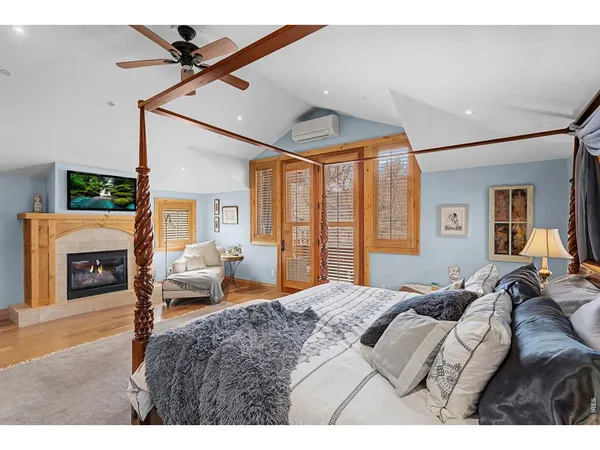 a bedroom with a large bed and a chandelier