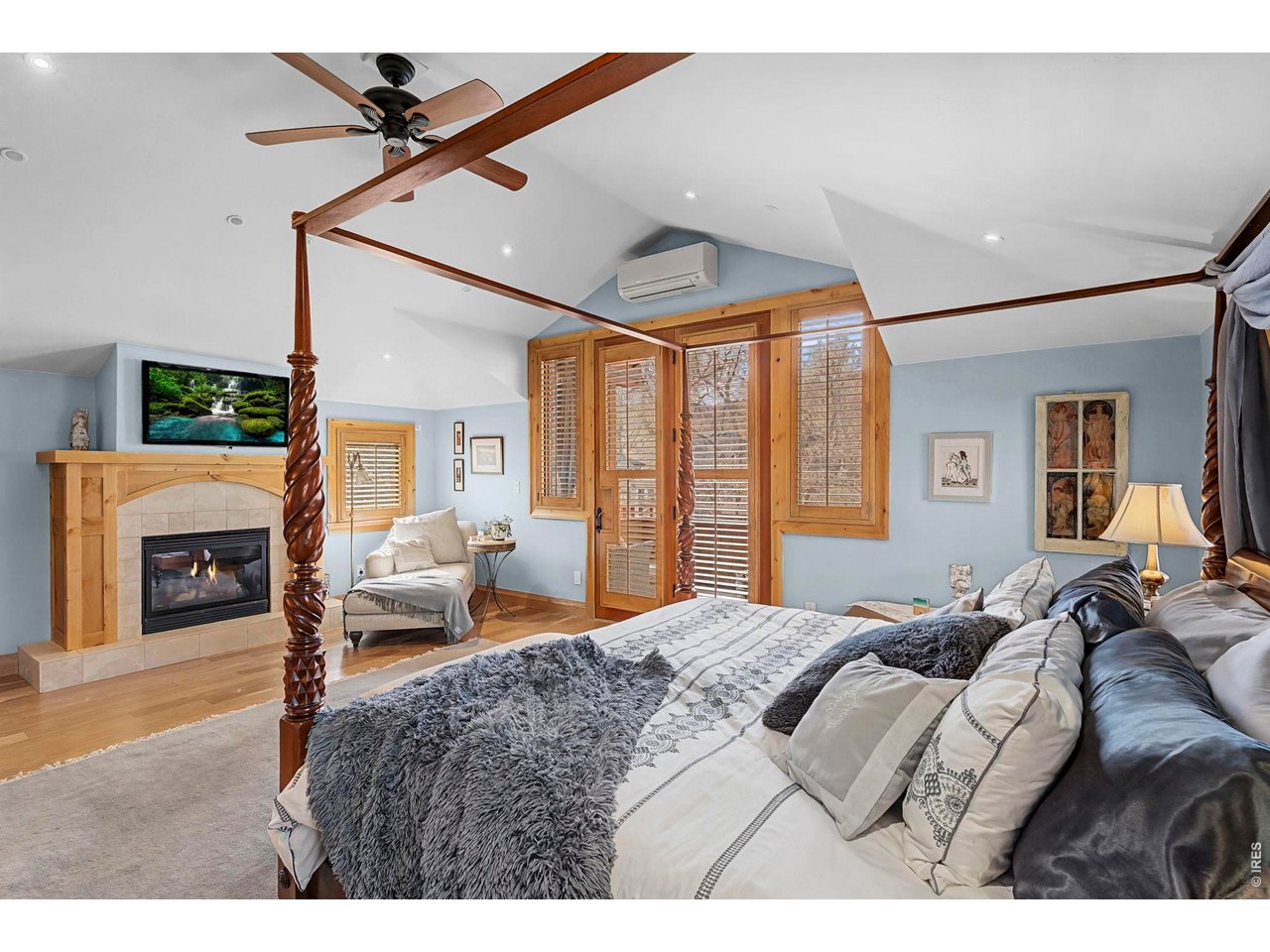 3135 11th Street Boulder, CO 80304 - Photo 26 of 50 a bedroom with a large bed and a chandelier