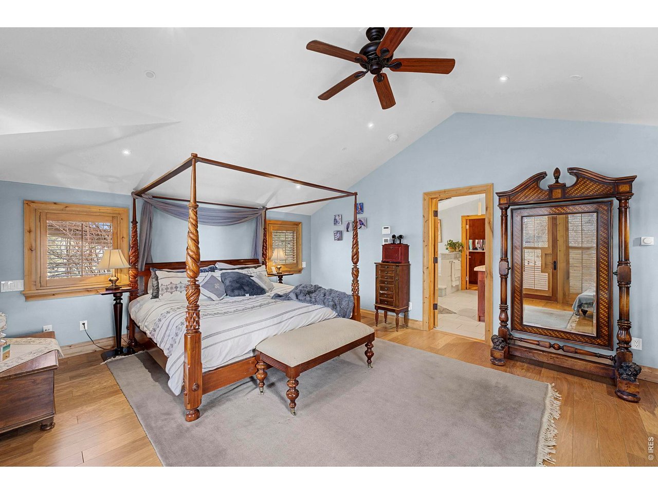 3135 11th Street Boulder, CO 80304 - Photo 27 of 50 a bedroom with a bed a dresser and a chandelier
