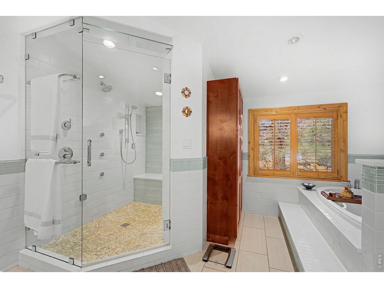 3135 11th Street Boulder, CO 80304 - Photo 29 of 50 a bathroom with a tub shower and sink
