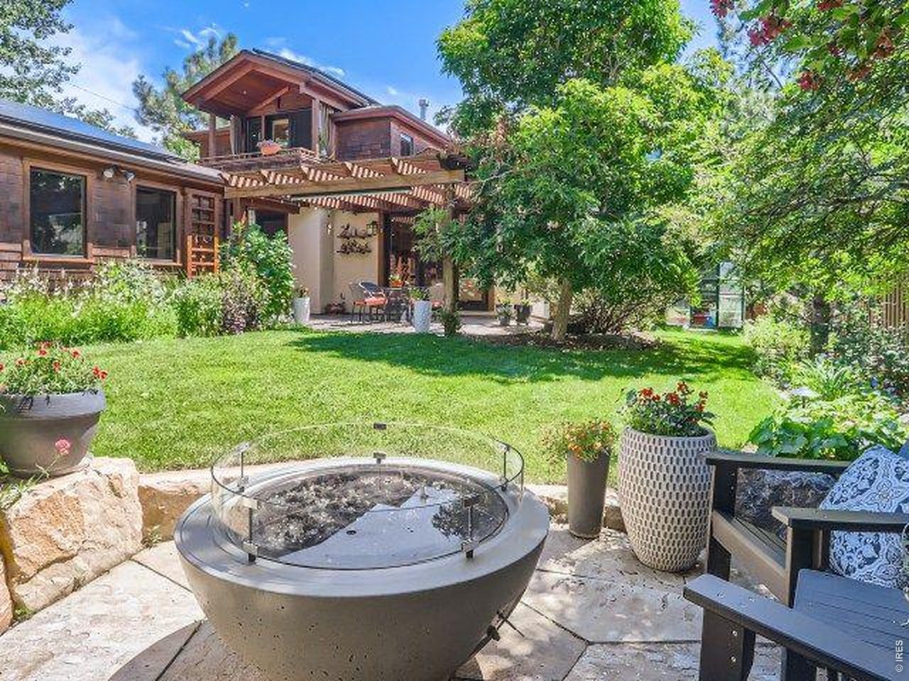 3135 11th Street Boulder, CO 80304 - Photo 49 of 50 a view of a house with backyard sitting area and garden