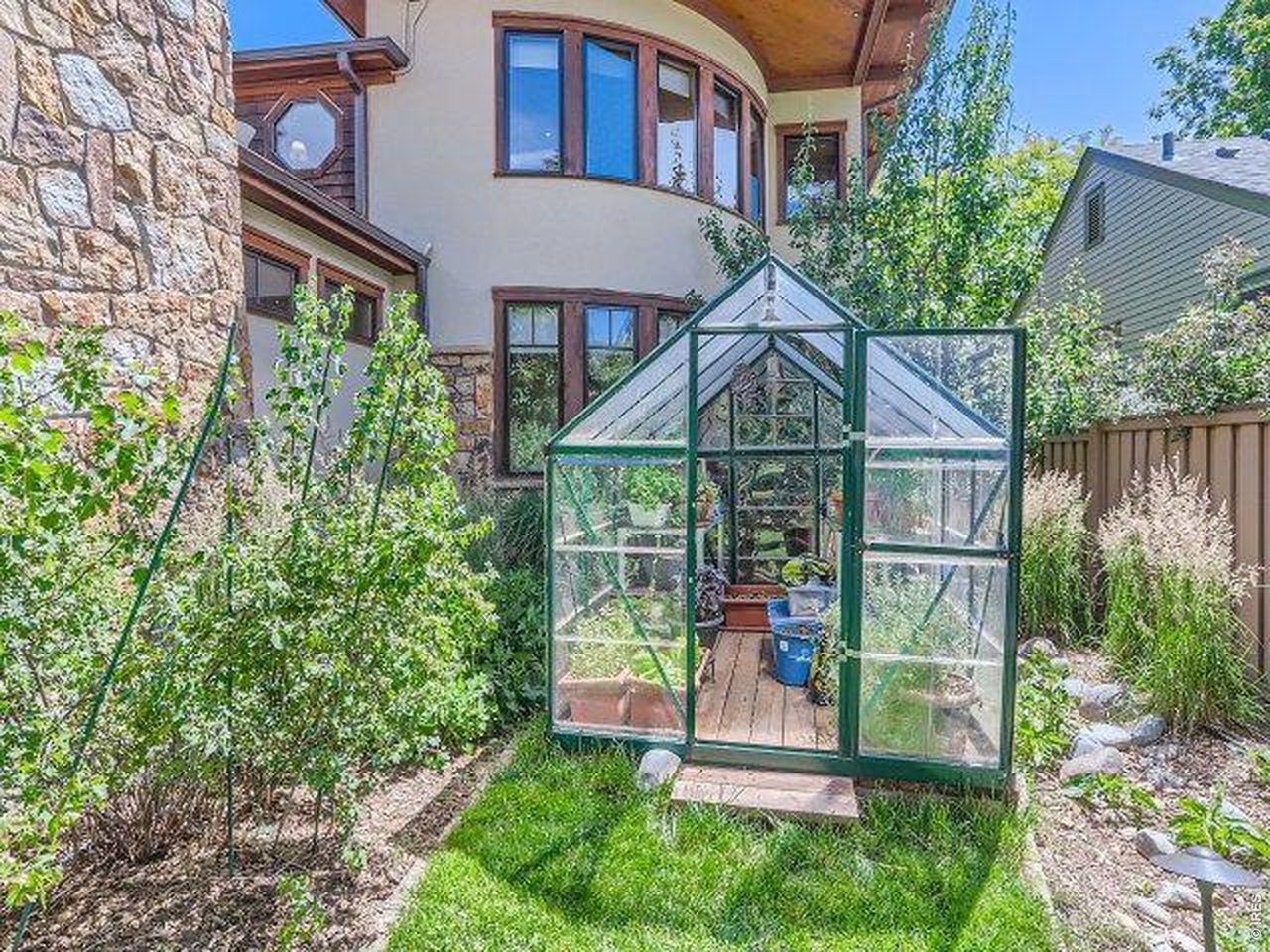 3135 11th Street Boulder, CO 80304 - Photo 50 of 50 a small garden area with tall trees in the background