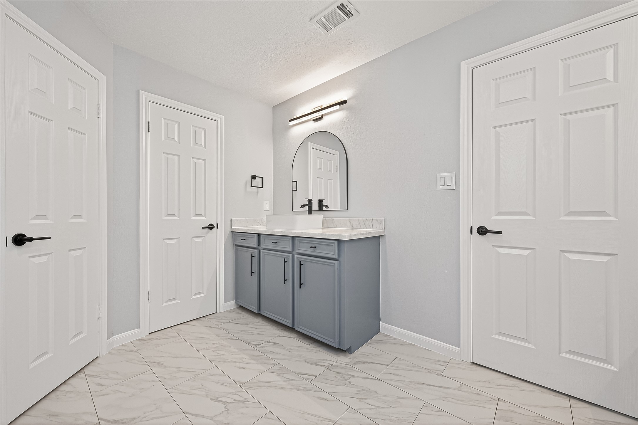 11506 Colonial Trail Drive Houston, TX 77066 - Photo 28 of 42 a bathroom with a sink vanity and a mirror