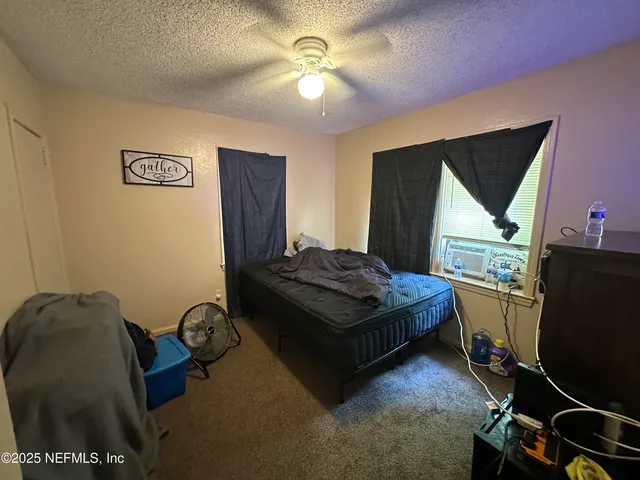 a bedroom with a bed and a chandelier