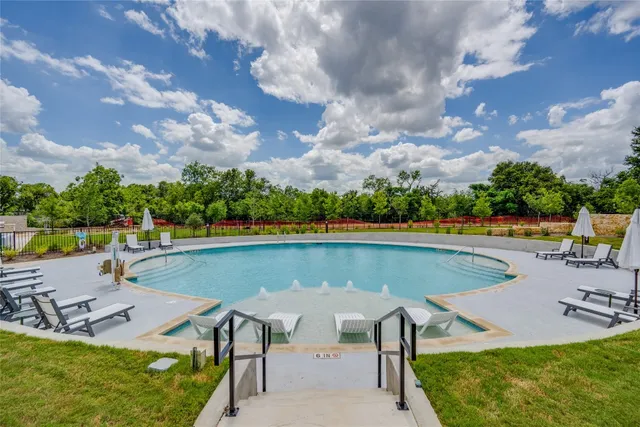 an aerial view of a house with swimming pool and patio