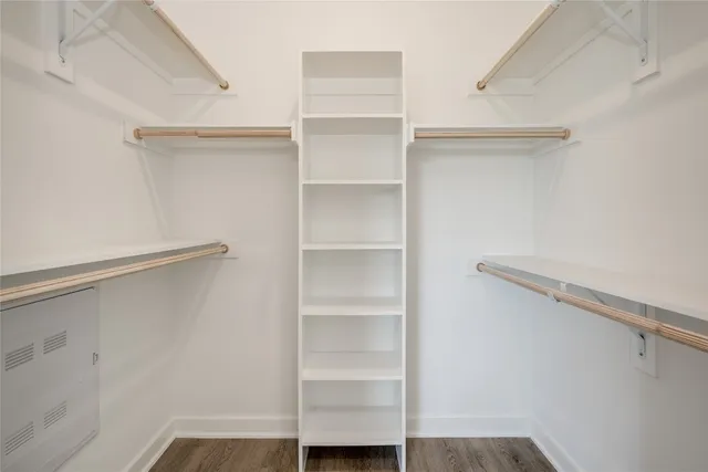 a view of walk in closet with empty racks