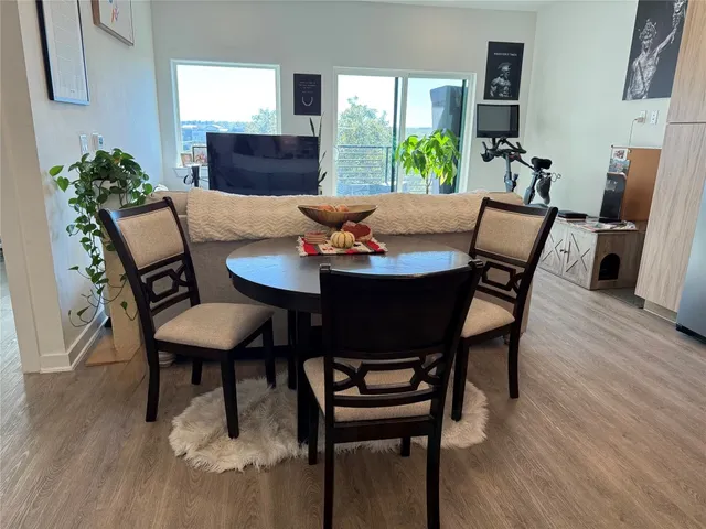 a view of a dining room with furniture window and wooden floor