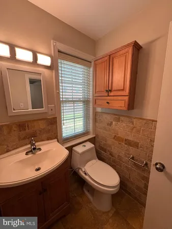 a bathroom with a sink a toilet and mirror